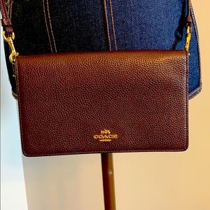 Coach wine colored, leather crossbody clutch